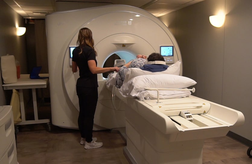 mri machine with patient and technician